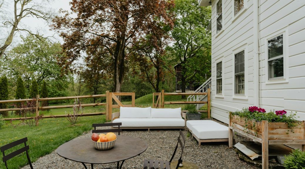 a patio with a table and chairs and a couch