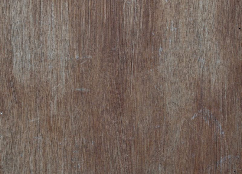 a close up of a wooden surface with scratches